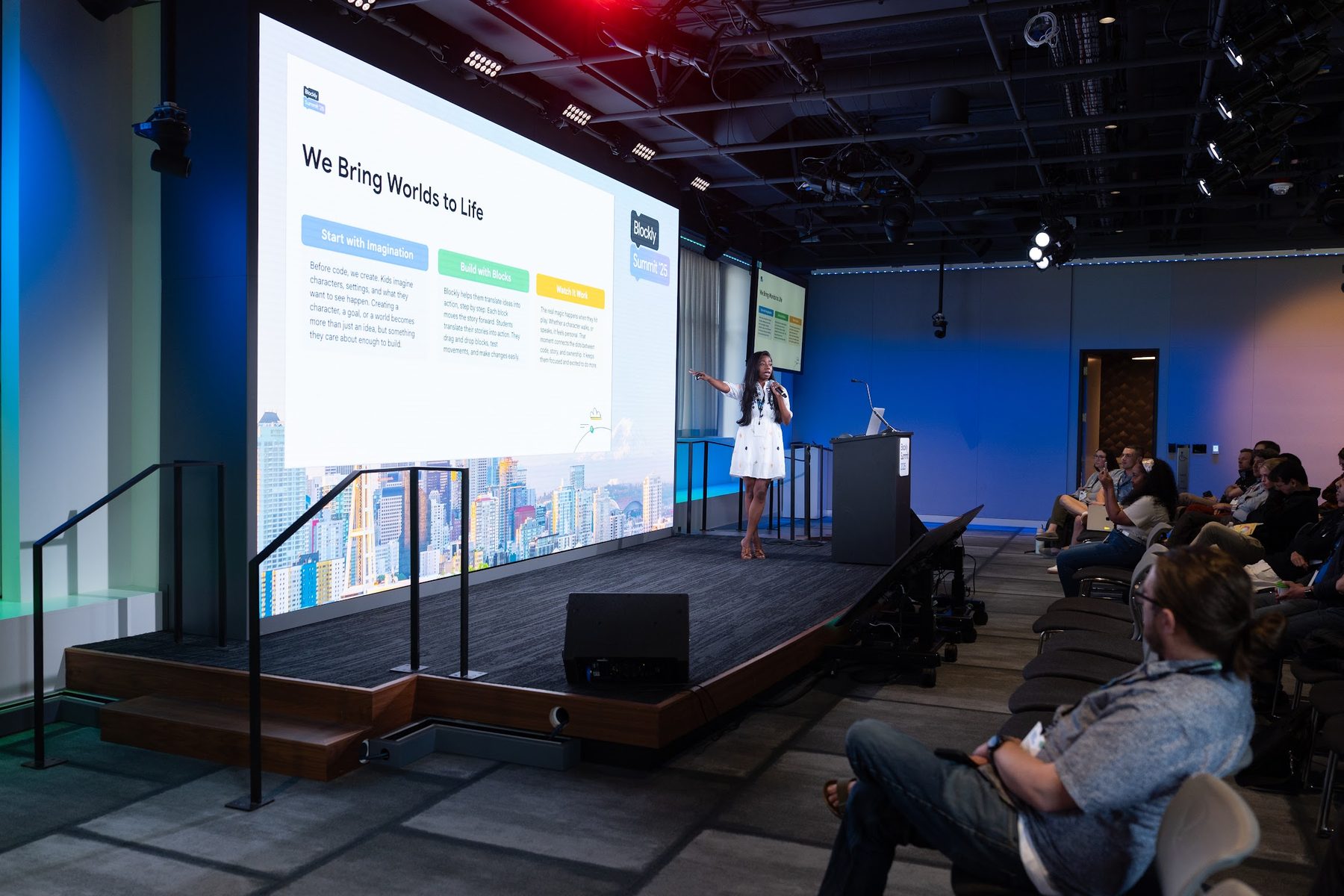 Nikita Collier presenting “We Bring Worlds to Life” on stage at Blockly Summit 2025
