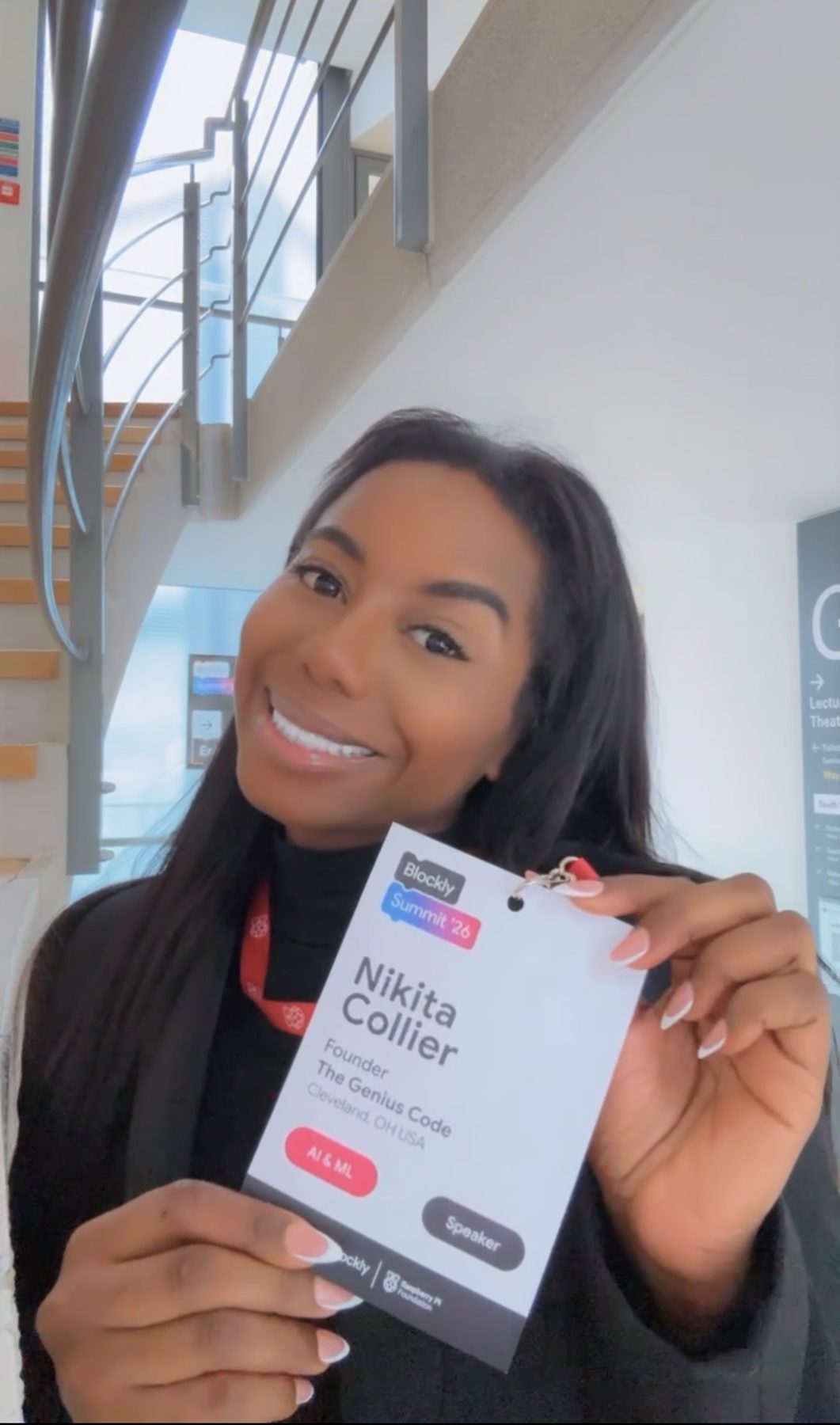 Nikita Collier holding her speaker badge at Blockly Summit 2026, Cambridge
